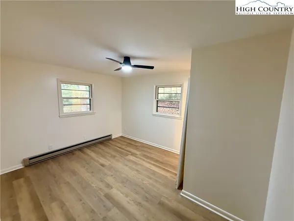 an empty room with windows and closet