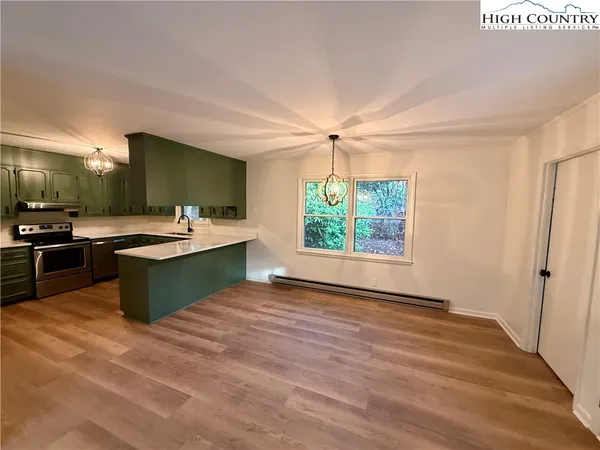 a kitchen with a sink and a stove top oven