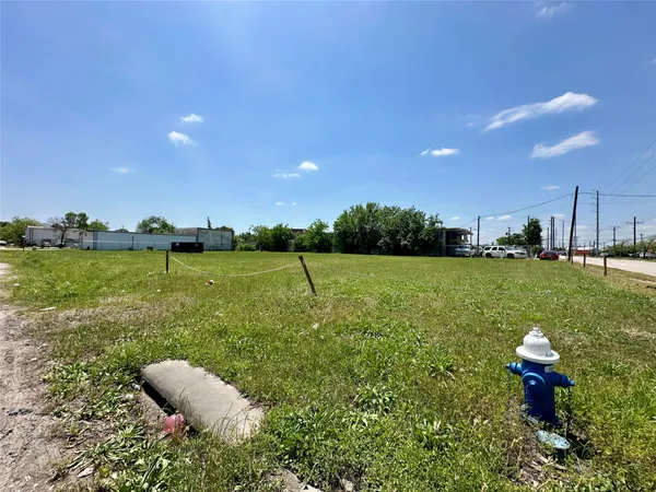 a view of a lake with a table and chairs in patio