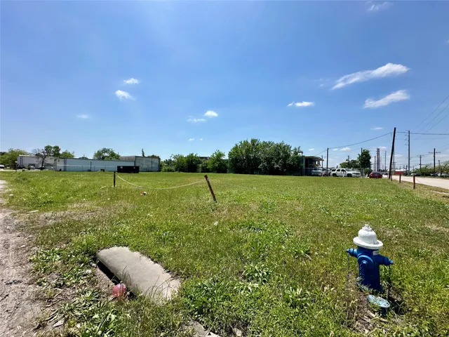 a view of a lake with a table and chairs in patio