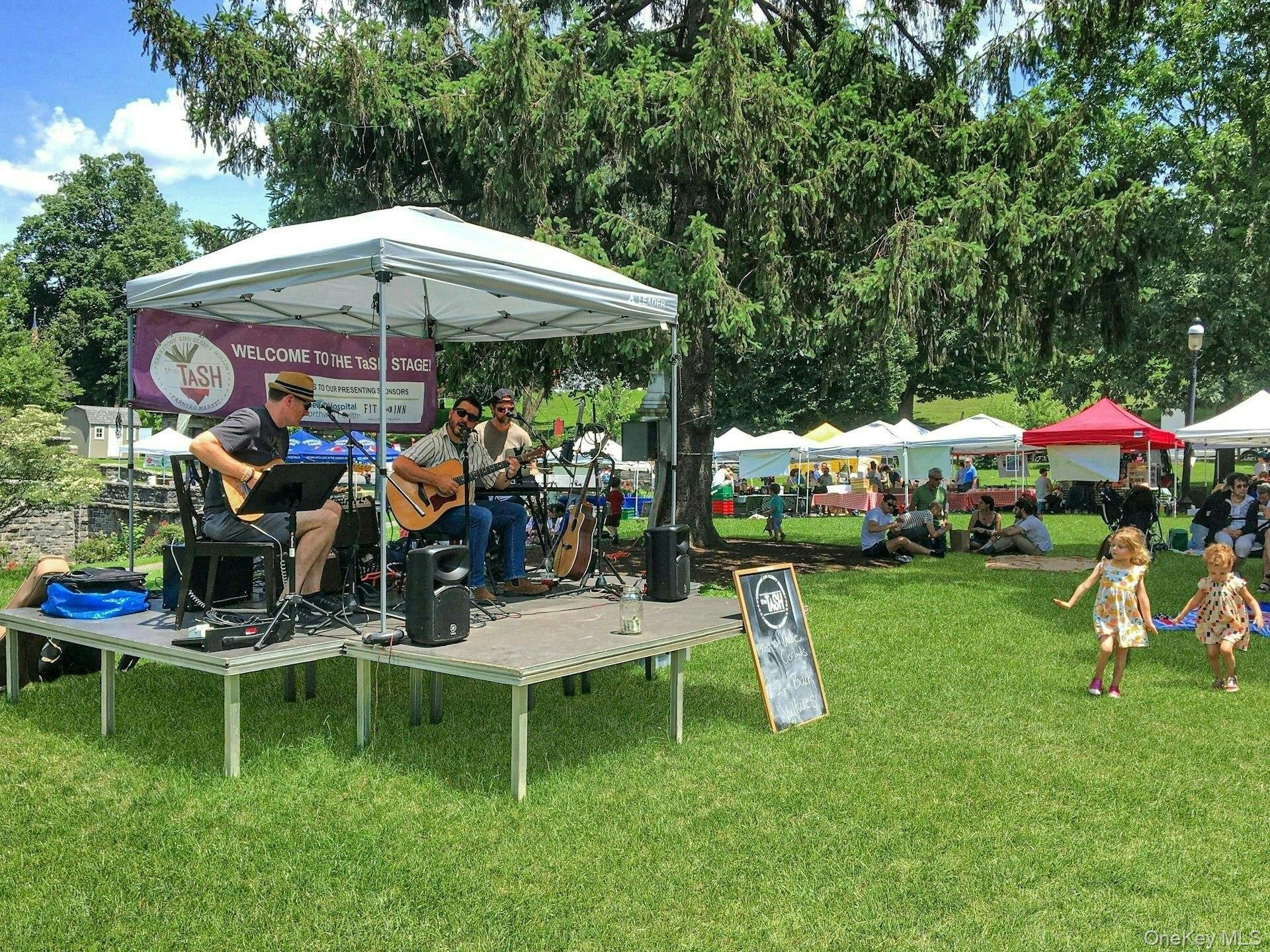 147 Beekman Avenue, Unit 1 Sleepy Hollow, NY 10591 - Photo 20 of 22 a view of a wooden table and chairs under an umbrella