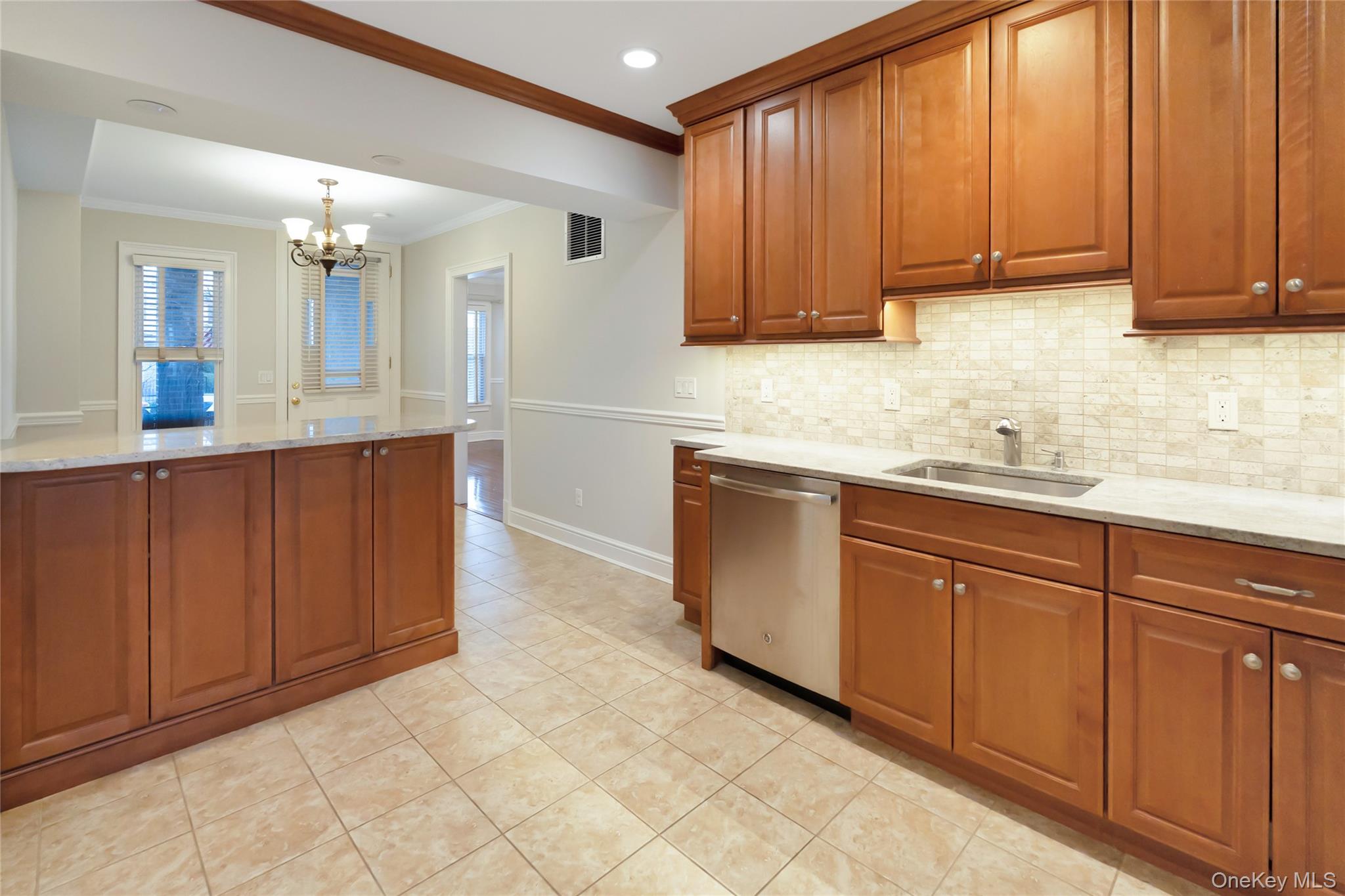 147 Beekman Avenue, Unit 1 Sleepy Hollow, NY 10591 - Photo 2 of 22 a kitchen with stainless steel appliances granite countertop a sink dishwasher stove and cabinets