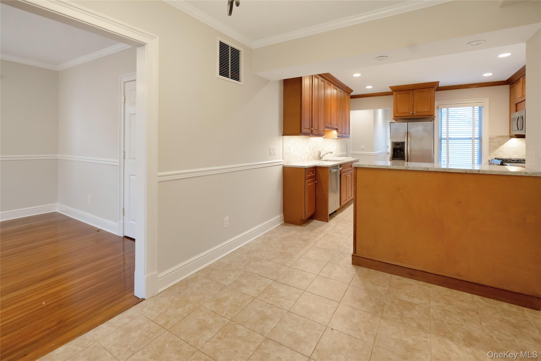 147 Beekman Avenue, Unit 1 Sleepy Hollow, NY 10591 - Photo 5 of 22 a view of kitchen with stainless steel appliances cabinets and wooden floor