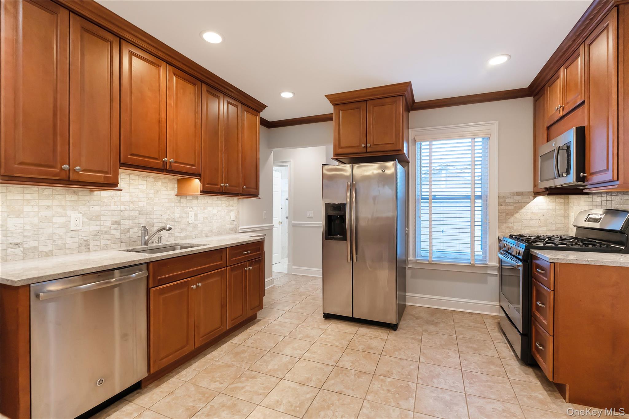 147 Beekman Avenue, Unit 1 Sleepy Hollow, NY 10591 - Photo 6 of 22 a kitchen with stainless steel appliances granite countertop a refrigerator and a sink