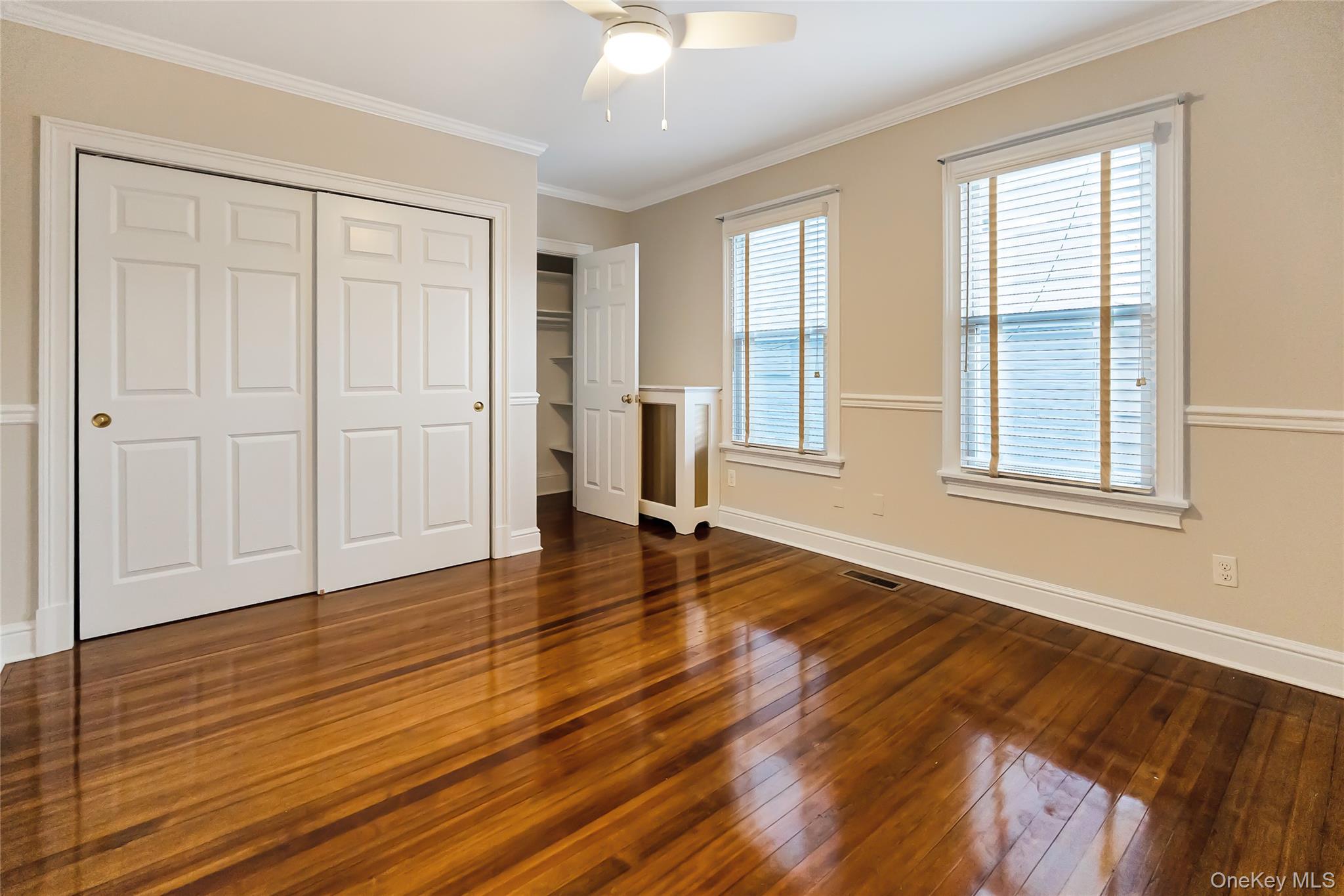 147 Beekman Avenue, Unit 1 Sleepy Hollow, NY 10591 - Photo 7 of 22 a view of an empty room with wooden floor and a window