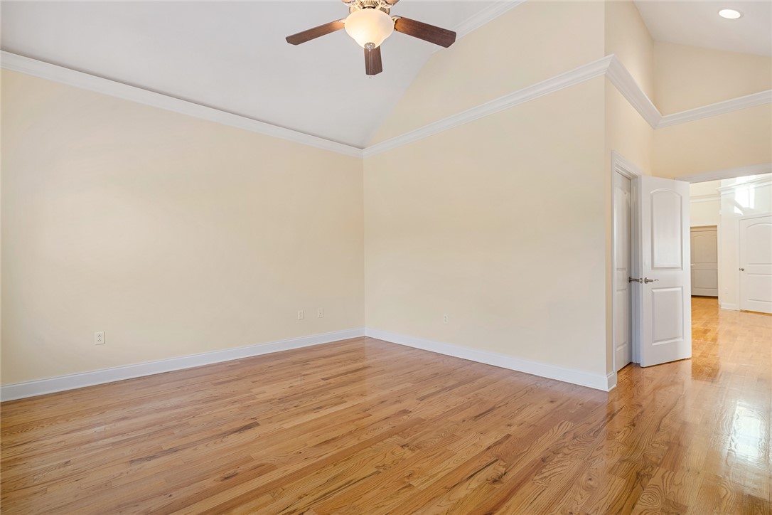 16 Oleander Drive Anderson, SC 29621 - Photo 22 of 37 Vast hardwood floors and soaring vaulted ceilings define this sun-drenched primary bedroom.