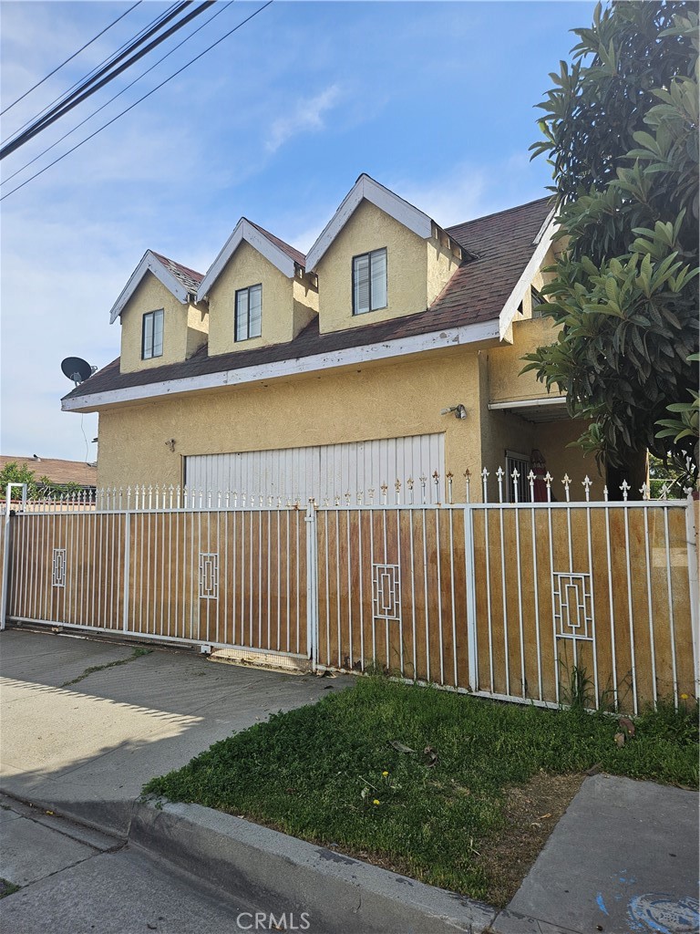 4276 Maxson Road El Monte, CA 91732 - Photo 17 of 17 a view of a white house with a small yard and wooden fence