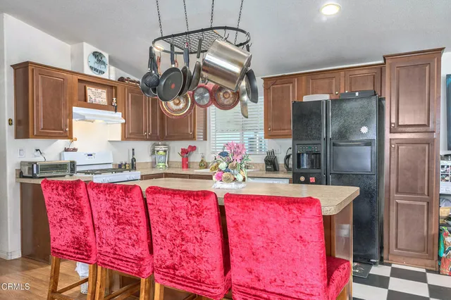 a kitchen with stainless steel appliances granite countertop a refrigerator and a sink
