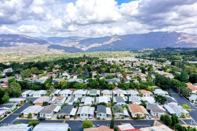 an aerial view of residential houses with outdoor space and street view