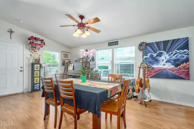 a view of a dining room with furniture window and wooden floor
