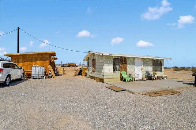 a view of a house with floor to ceiling windows and a basket ball poll