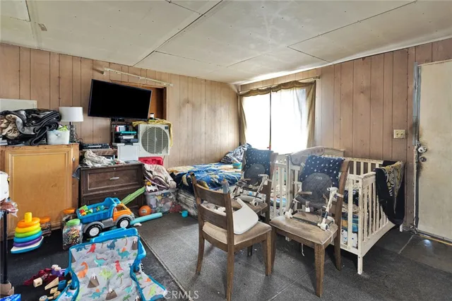 a bedroom with a bed and flat screen tv