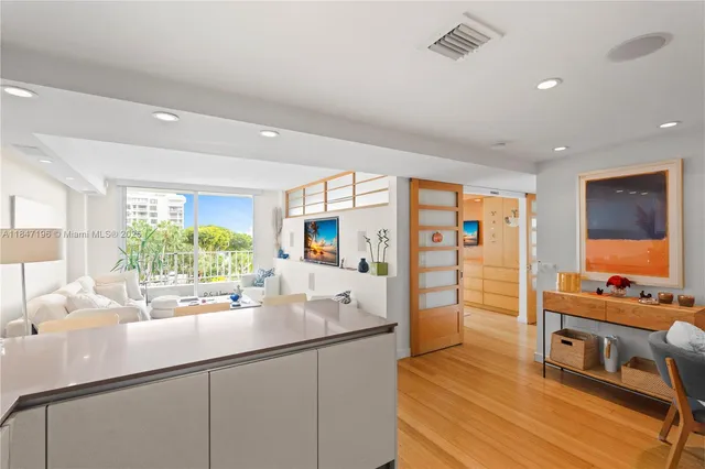 a large kitchen with a large window and stainless steel appliances