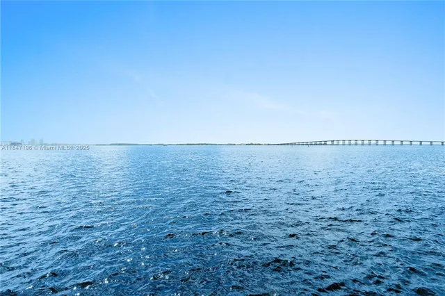 a view of ocean with green space