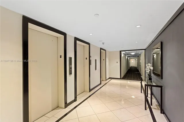 a bathroom with a sink mirror and toilet