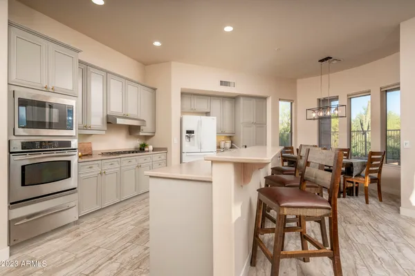 a kitchen with a sink stove and refrigerator