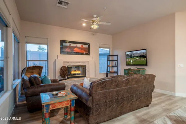 a spacious bedroom with a bed and wooden floor