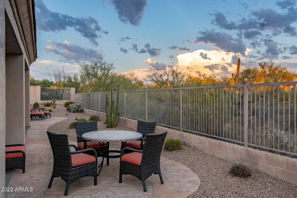 a backyard of a house with table and chairs