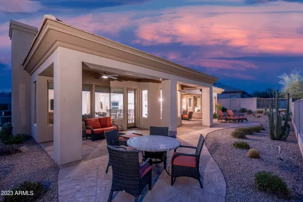 a living room with lots of furniture and view of kitchen