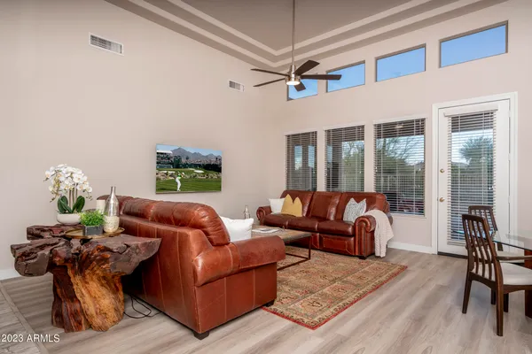 a living room with furniture a ceiling fan and a rug