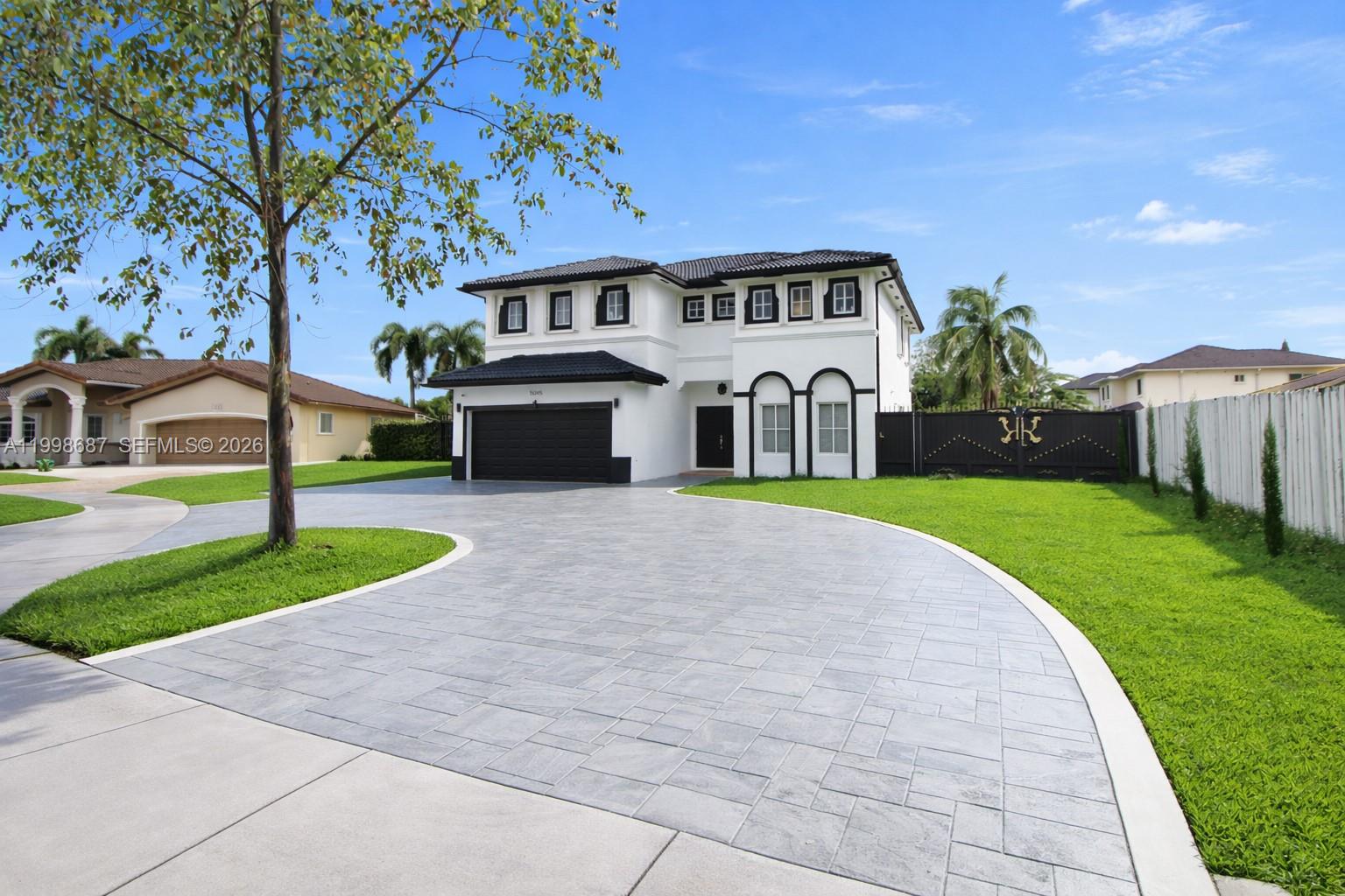 15045 Southwest 38th Terrace Miami, FL 33185 - Photo 1 of 37 a front view of a house with a garden and yard