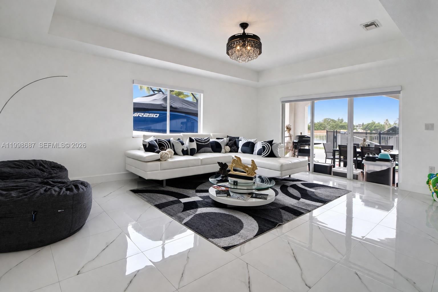15045 Southwest 38th Terrace Miami, FL 33185 - Photo 11 of 37 a living room with furniture and a rug