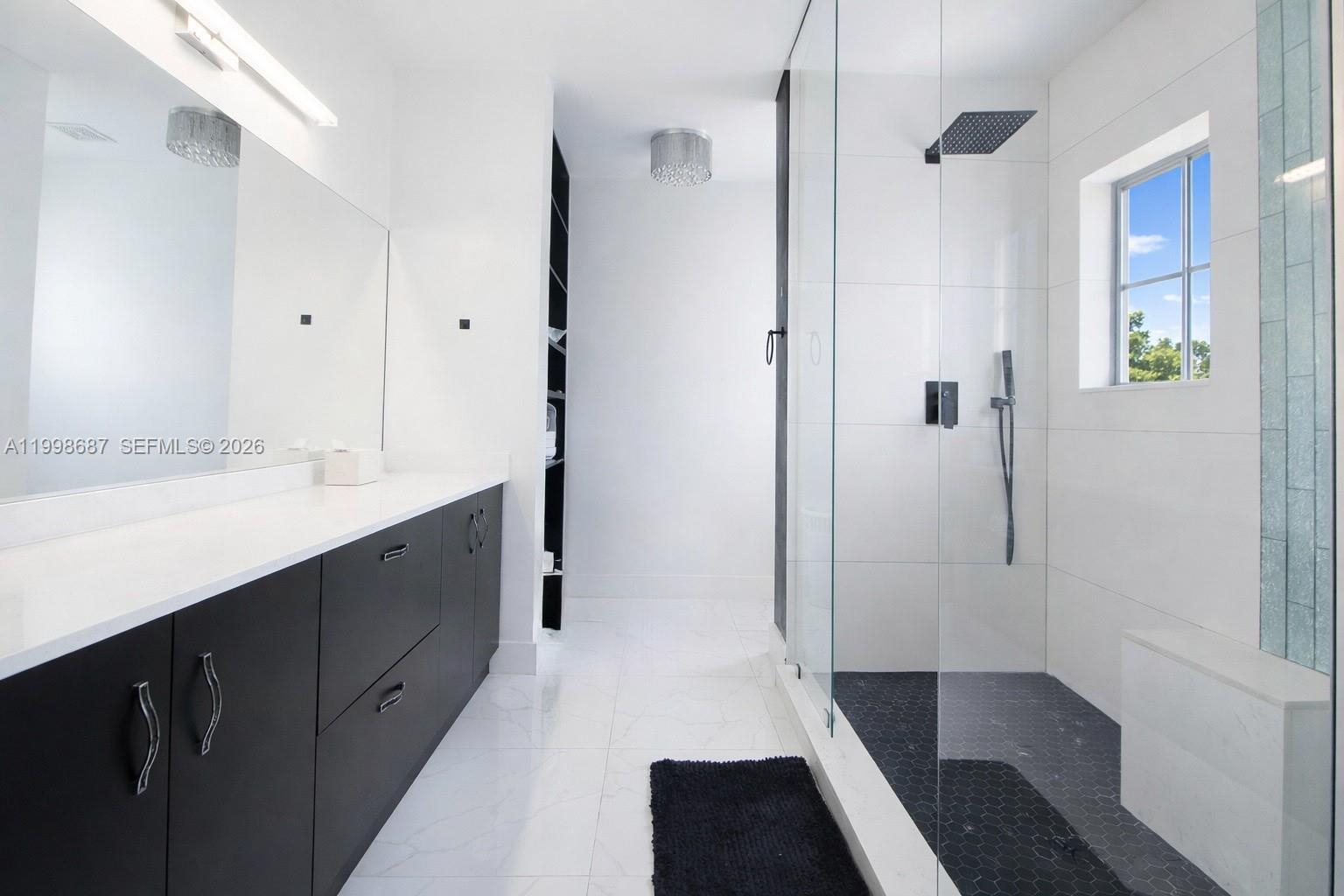 15045 Southwest 38th Terrace Miami, FL 33185 - Photo 20 of 37 a bathroom with a double vanity sink and mirror