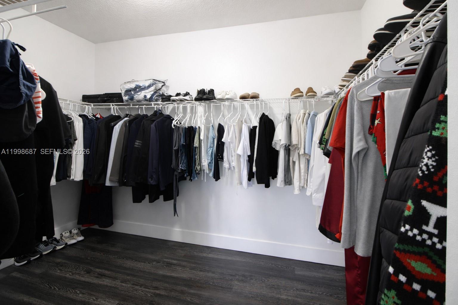 15045 Southwest 38th Terrace Miami, FL 33185 - Photo 22 of 37 a view of walk in closet with clothes and shoes