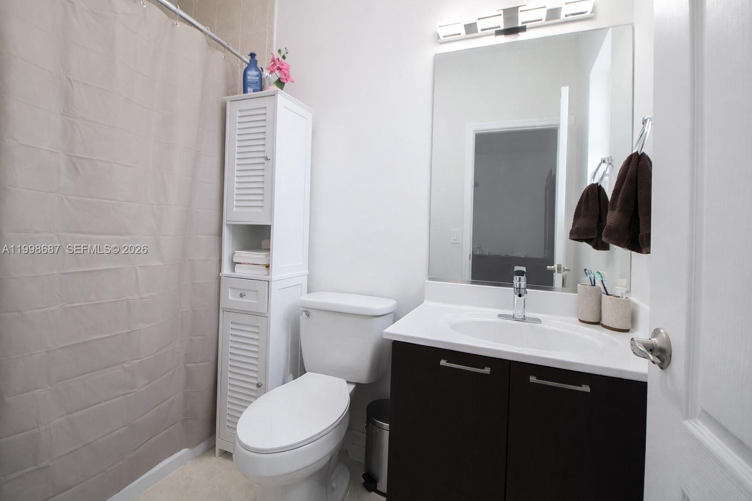 15045 Southwest 38th Terrace Miami, FL 33185 - Photo 27 of 37 a bathroom with a sink a toilet and shower
