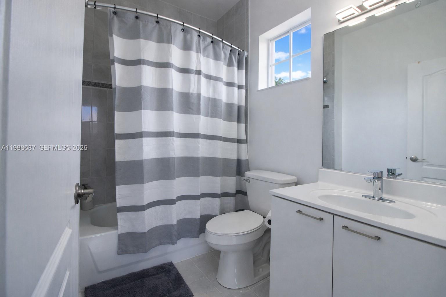 15045 Southwest 38th Terrace Miami, FL 33185 - Photo 29 of 37 a bathroom with a sink a toilet and shower