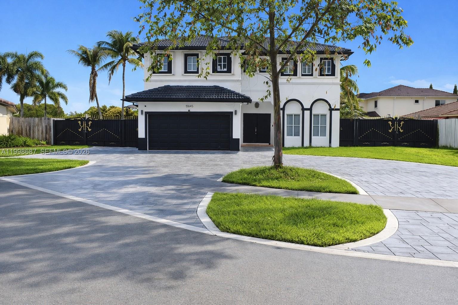 15045 Southwest 38th Terrace Miami, FL 33185 - Photo 3 of 37 a front view of a house with a yard and garage