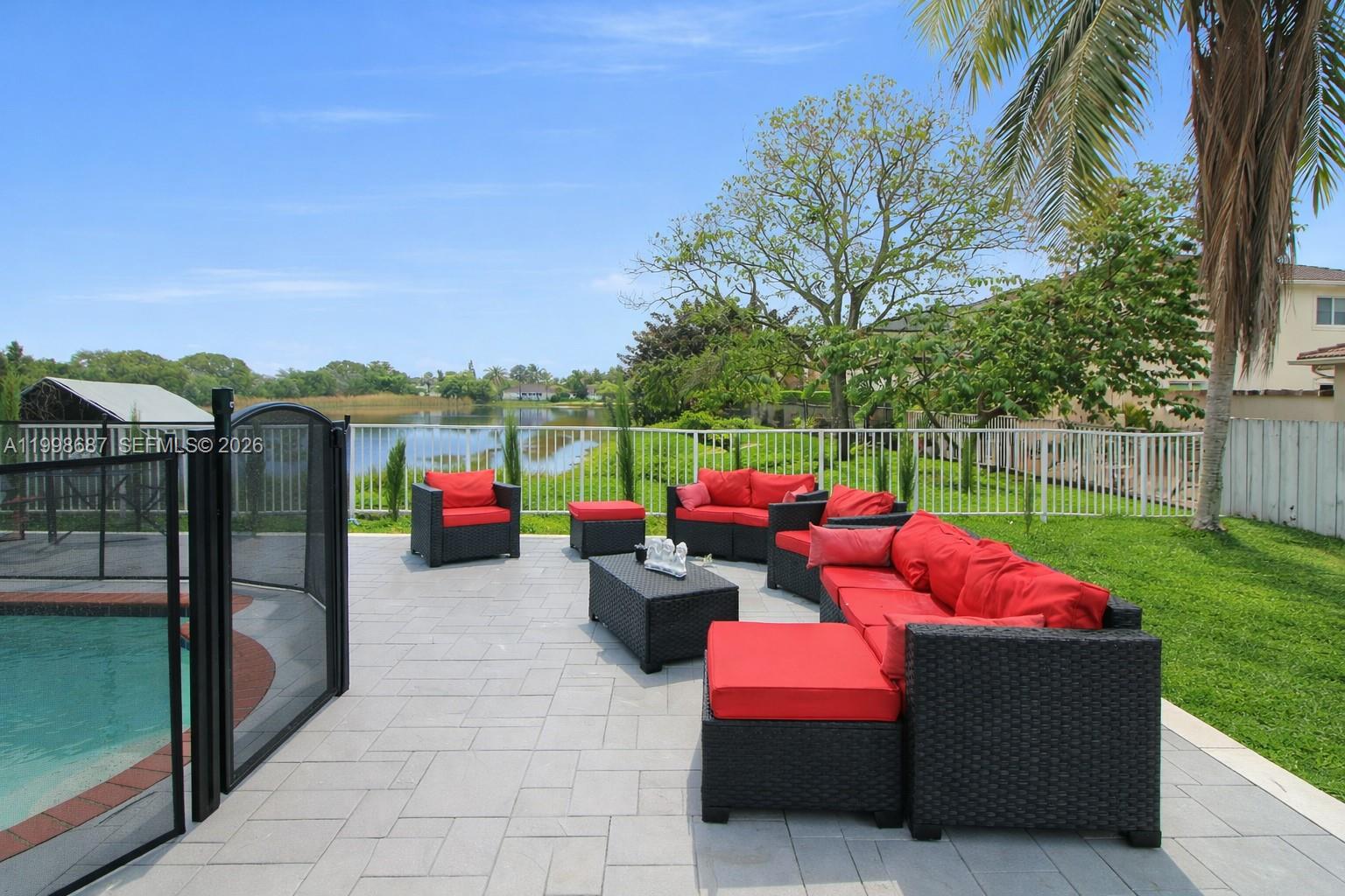 15045 Southwest 38th Terrace Miami, FL 33185 - Photo 34 of 37 a view of yard with seating area and trees in the background