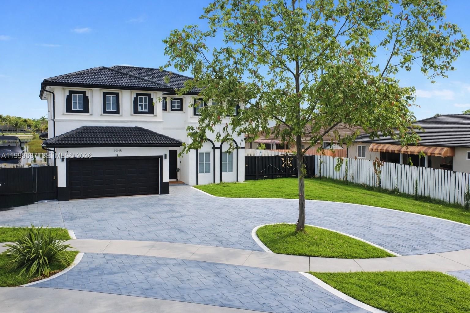 15045 Southwest 38th Terrace Miami, FL 33185 - Photo 5 of 37 a front view of a house with a yard and garage