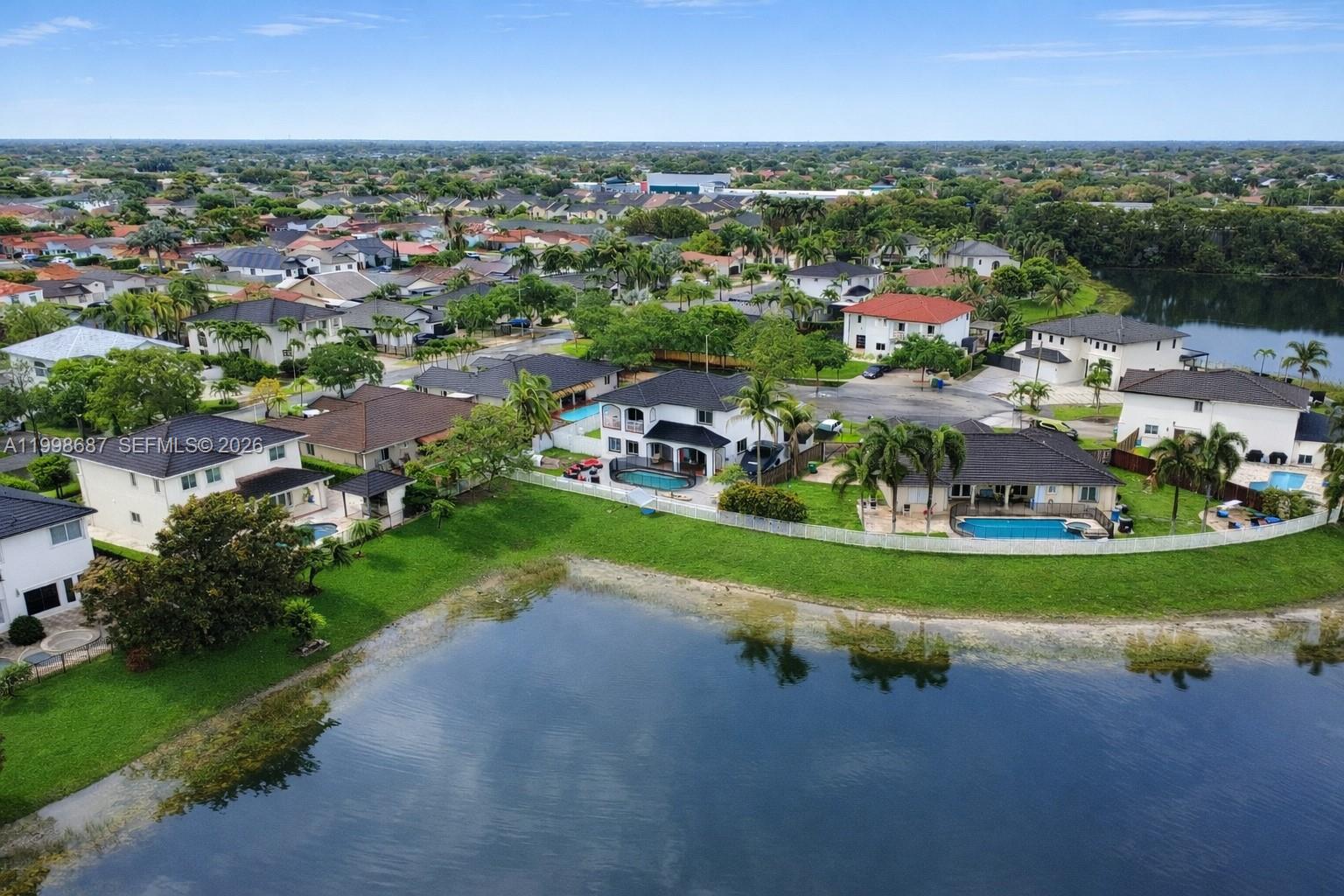 15045 Southwest 38th Terrace Miami, FL 33185 - Photo 10 of 37 an aerial view of a house with a yard and lake view
