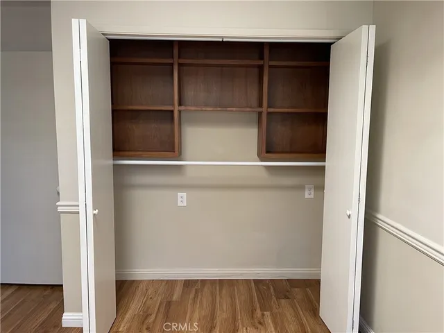 a view of walk in closet with empty racks