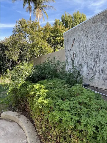 a view of a garden with a building in the background