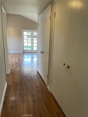 a view of hallway with wooden floor