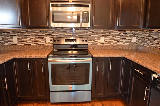 129 Whitetail Ridge Clarksville, TN 37040 - Photo 11 of 20 a kitchen with granite countertop a stove and a microwave