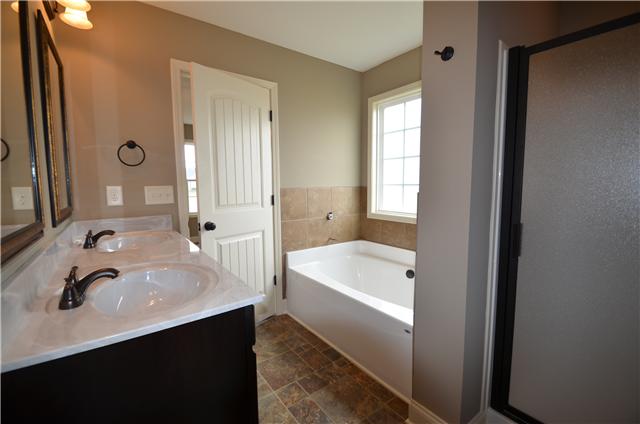 129 Whitetail Ridge Clarksville, TN 37040 - Photo 15 of 20 a bathroom with a sink a tub and a mirror