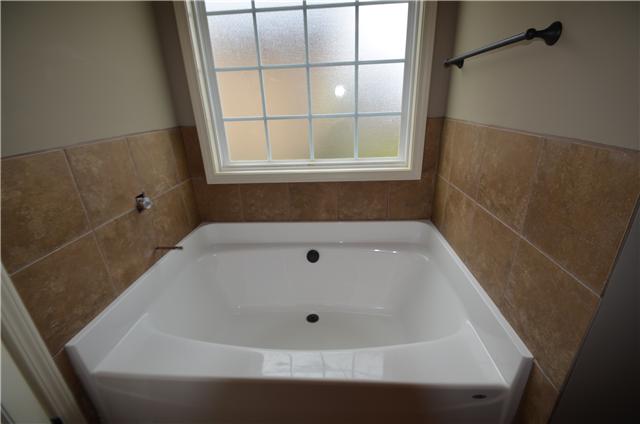 129 Whitetail Ridge Clarksville, TN 37040 - Photo 16 of 20 a bath tub sitting in a bathroom next to a window