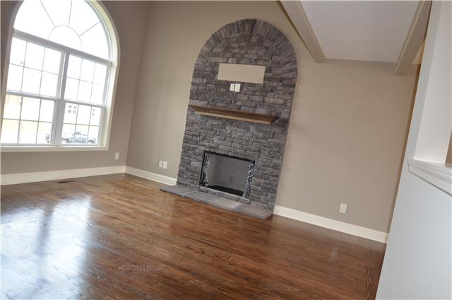 129 Whitetail Ridge Clarksville, TN 37040 - Photo 17 of 20 an empty room with wooden floor fireplace and windows