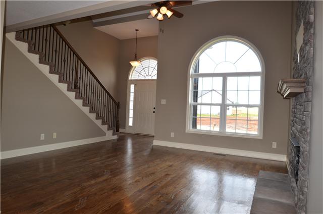 129 Whitetail Ridge Clarksville, TN 37040 - Photo 5 of 20 an empty room with wooden floor fan and windows