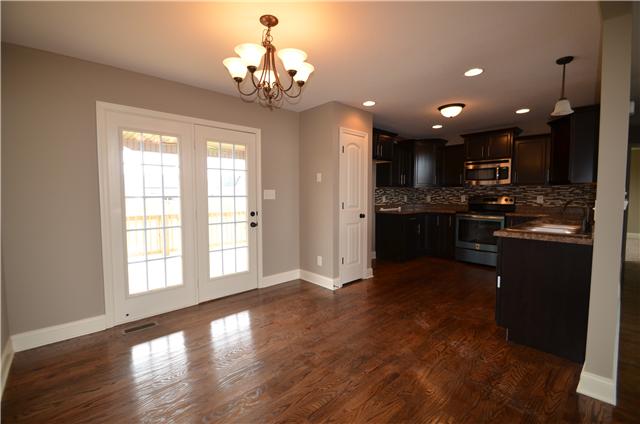 129 Whitetail Ridge Clarksville, TN 37040 - Photo 9 of 20 a open kitchen with stainless steel appliances granite countertop a refrigerator stove top oven and cabinets with wooden floor
