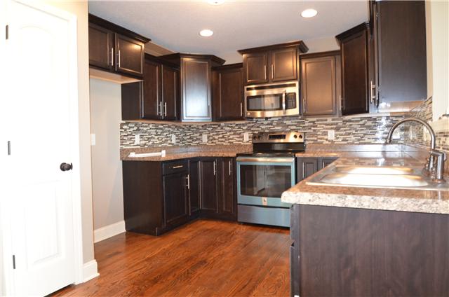 129 Whitetail Ridge Clarksville, TN 37040 - Photo 10 of 20 a kitchen with stainless steel appliances granite countertop a stove a sink and a refrigerator