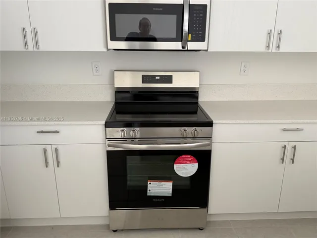 a stove top oven sitting inside of a kitchen