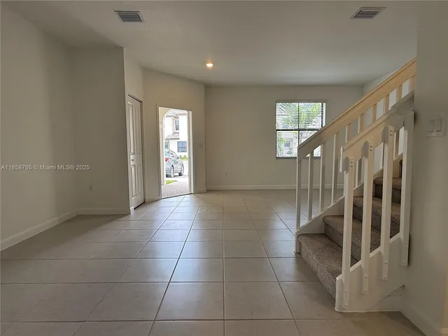 a view of entryway with stairs and a window