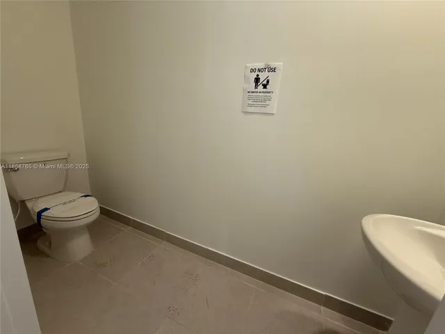 a white toilet sitting next to a white walls