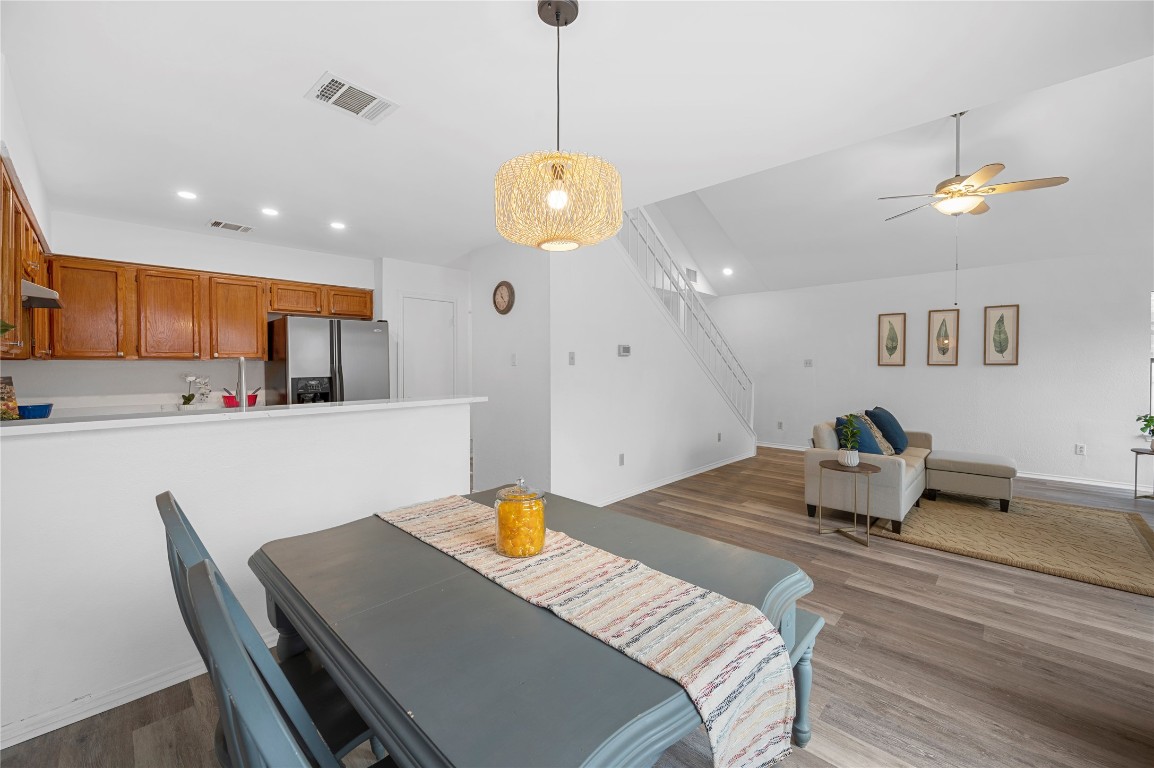 7705 Grovedale Trail Austin, TX 78729 - Photo 14 of 25 a living room with kitchen island furniture and a chandelier