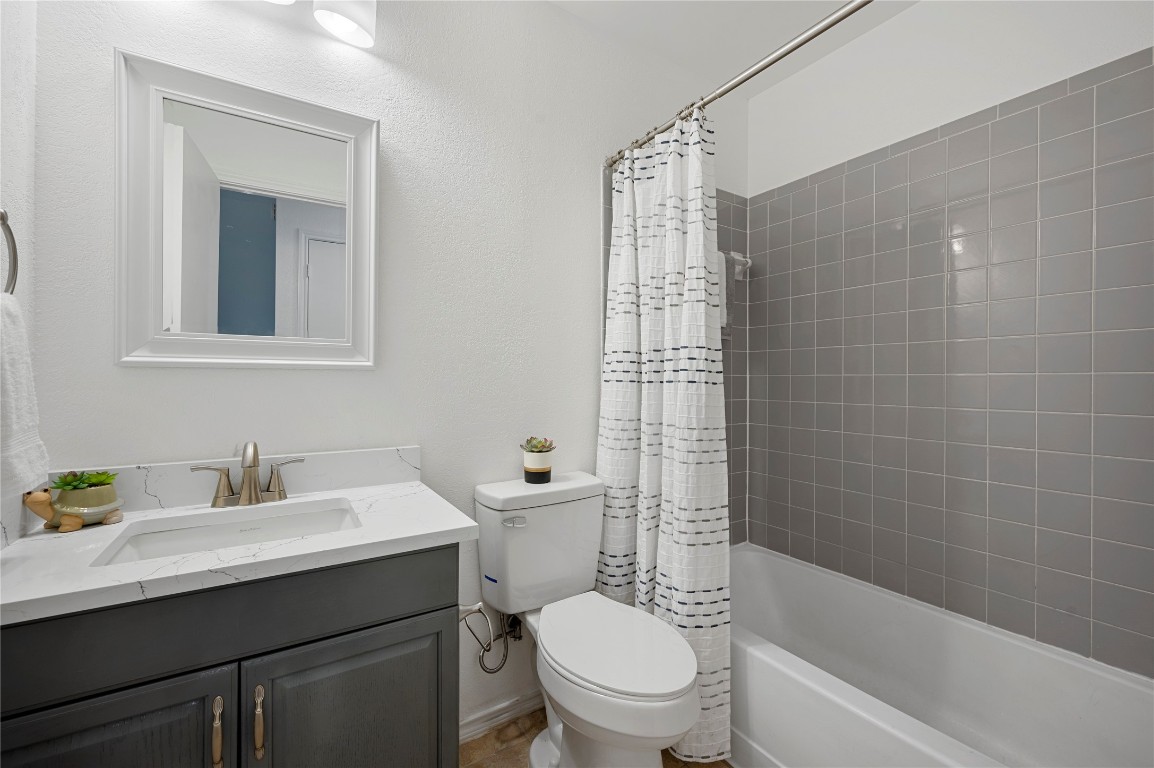 7705 Grovedale Trail Austin, TX 78729 - Photo 22 of 25 a bathroom with a sink toilet and shower