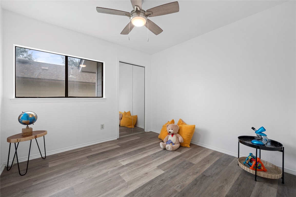 7705 Grovedale Trail Austin, TX 78729 - Photo 23 of 25 a room with furniture and wooden floor